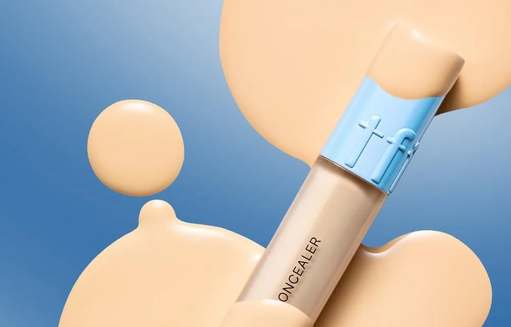 A TFIT Idol Cover Concealer tube lying on drops of concealer