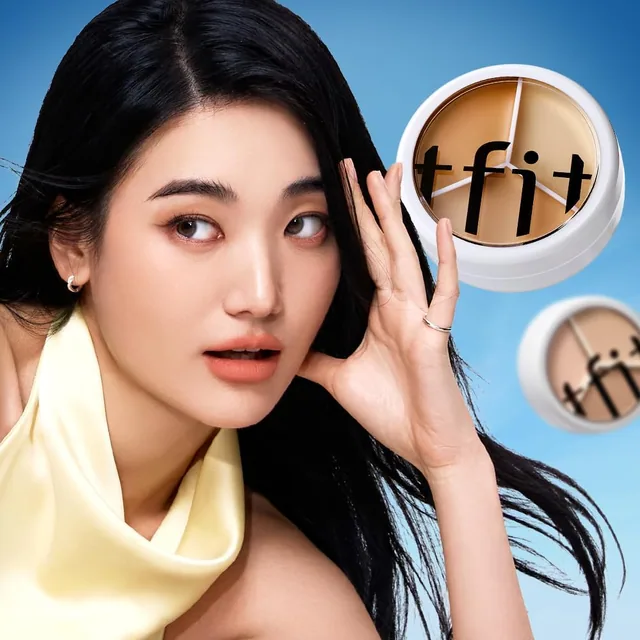 A model holding the TFIT 3 Color Concealer Palette beside her face