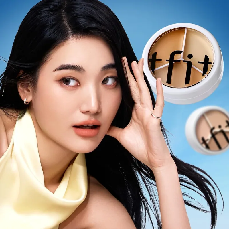 A model holding the TFIT 3 Color Concealer Palette beside her face