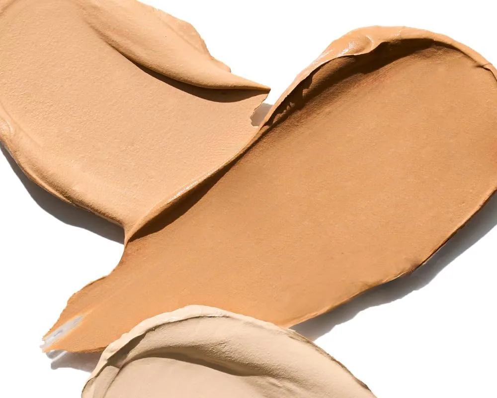 Two smears of TFIT concealer cream, a light beige and a tan