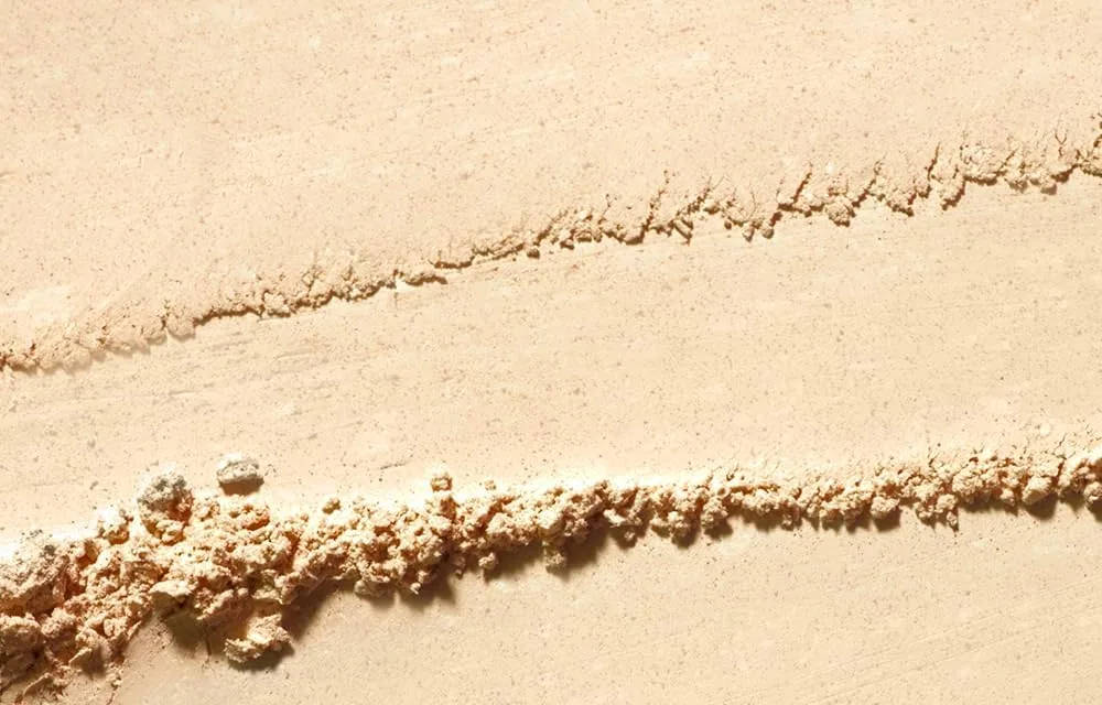 TFIT finishing powder raked into lines to show its fine grain