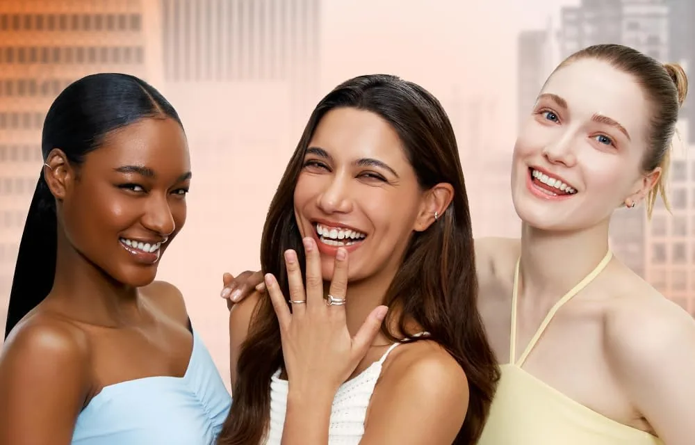 Three laughing models of different skin depths wearing TFIT Sleek Fit Cover Foundation